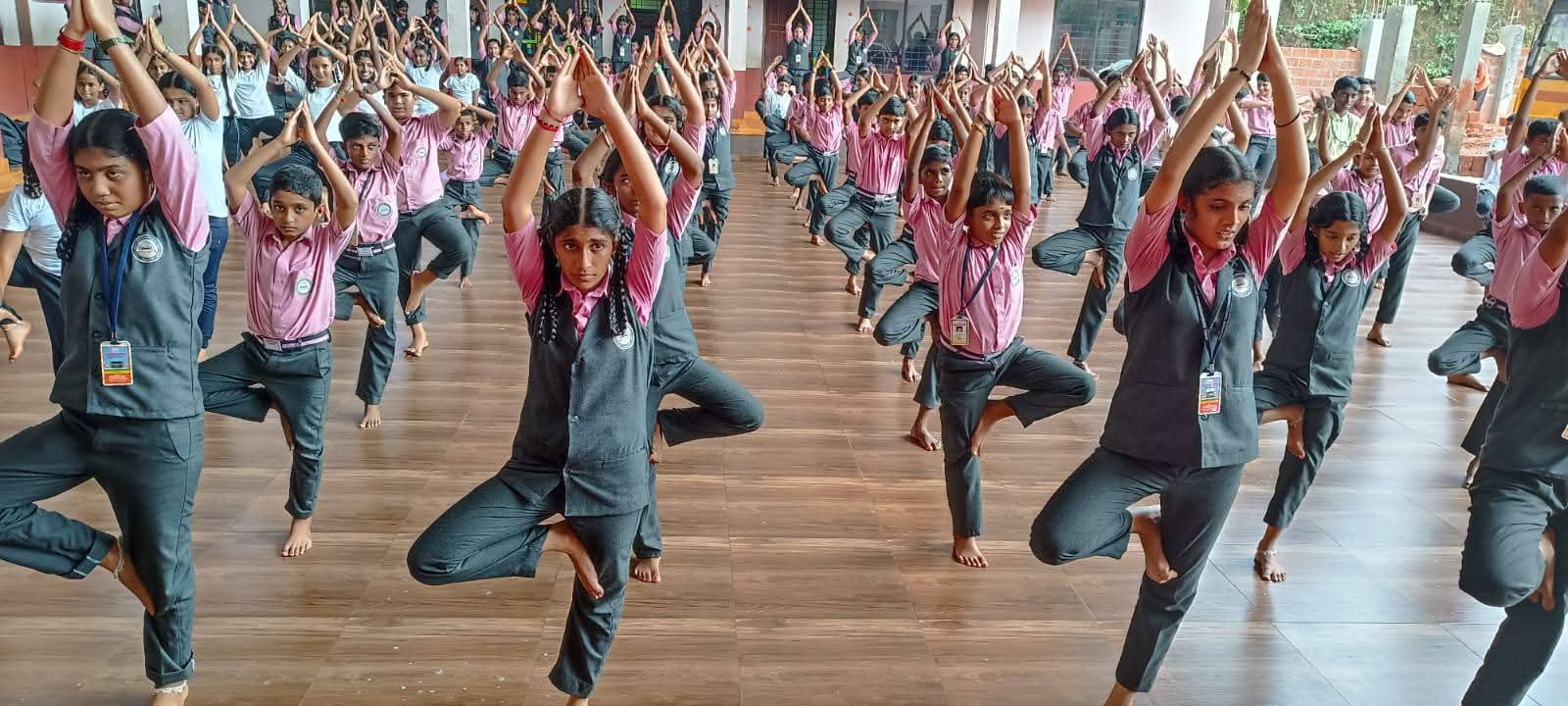 Students performing yoga in the auditorium